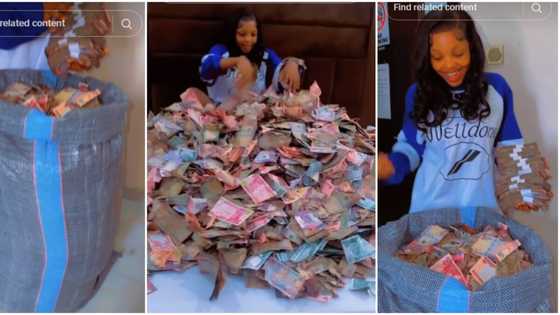 "Mummy of Lagos money": Nigerian lady flaunts big sack filled with cash, scatters them on her bed