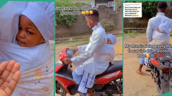 Man who goes to white garment church carries baby to Sunday service on his back while riding a bike