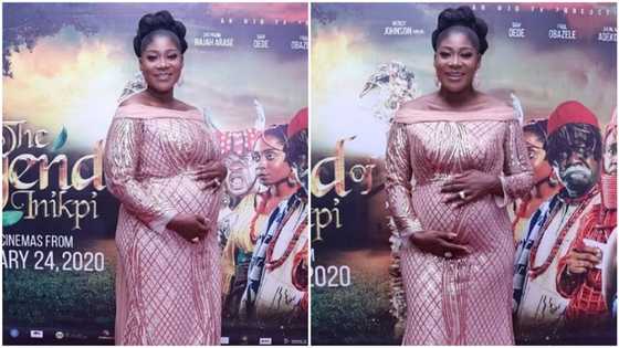 Mercy Johnson cradles her growing baby bump as she steps out for her movie premiere (photos)