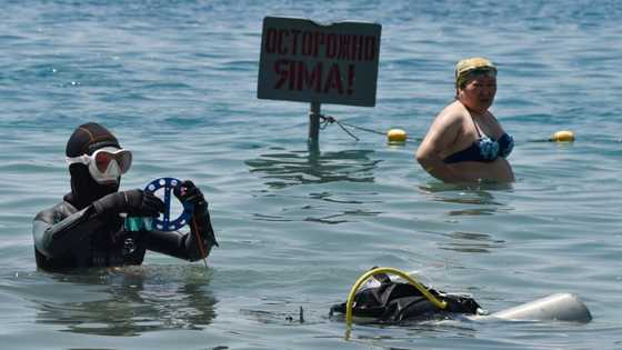 Rubbish-clearing divers come to rescue of 'pearl of Kyrgyzstan'