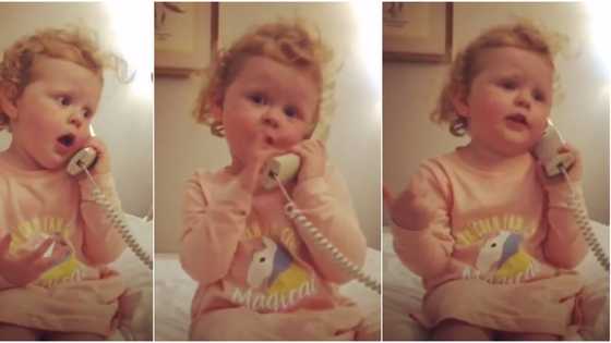 Little girl sends social media into frenzy as she fakes telephone conversation (video)
