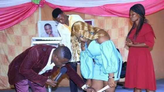 Outrage as Nigerians react to photo of pastor removing lady's undies during deliverance for her to get pregnant