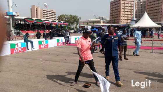 Iconic photo of pro-Tinubu supporter waving his flag at the Eagle Square