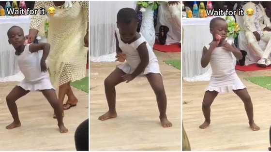 "I just dey smile": Video shows smart girl in white gown picking money while dancing, she puts it in her dress
