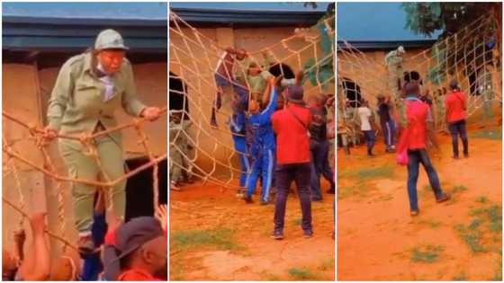 Funny moment 'corper' got stuck inside net during camp's exercise, men rush to carry her in video
