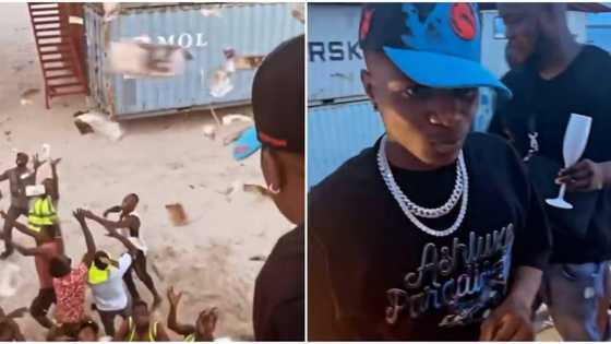 Wizkid causes frenzy as he makes cash rain on fans during visit to Lagos beach