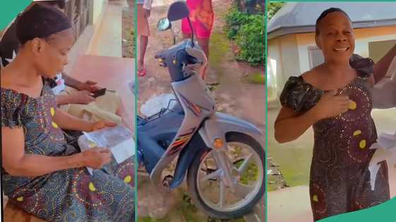 Nigerian mother happily hugs her son who bought her brand new motorcycle