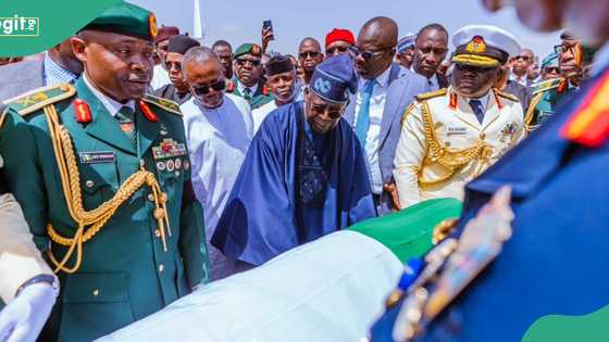 Iconic photo, video show Tinubu standing beside Buhari’s body, Nigerians react
