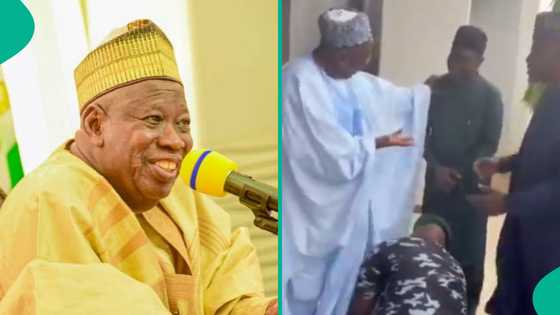 Knocks as police officer caught tying Ganduje's shoelaces, video trends