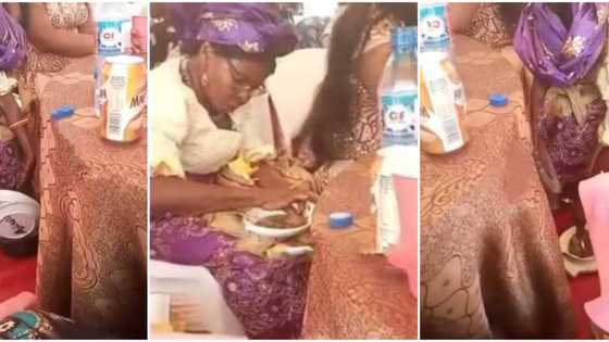 Reactions as well-dressed woman is caught in viral video putting food she was served at party into a nylon