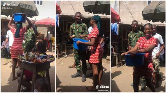 "Don't try it again o": Reactions as young lady plays prank on soldier in the market, officer reacts in video