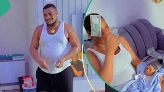 “He go collectam back?”: Nigerian man showers his wife with cash as she gives birth to twins