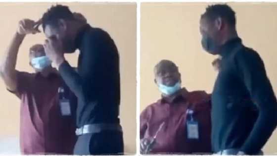 Abuja lecturer turns classroom into barbing salon, uses scissors to shave student with dreadlocks