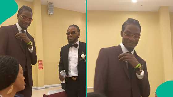 Nigerian mother reacts with disbelief as her two grown sons braid their hair