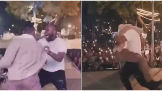 Mayorkun pulls a surprise on Davido at Abuja concert, singer jumps excitedly around, lifts him up like a baby