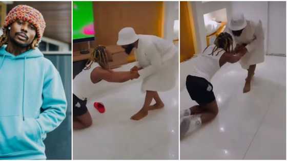 Asake screams in video as Woli Arole gives him hot 'spiritual slaps', makes him kneel for special prayers