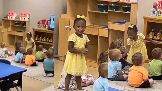 Little girl gets a surprise visit from father, taps colleagues to share in her excitement but they watch on