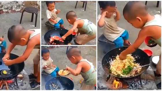 Little boy cooks 'rice' over wood fire, dishes to his younger one in sweet clip, many praise his cooking skill