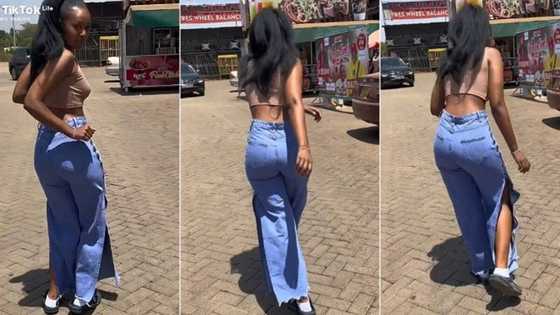 "Go for modelling": Pretty lady in crop top and jeans catwalks, whines her waist on the road, video trends