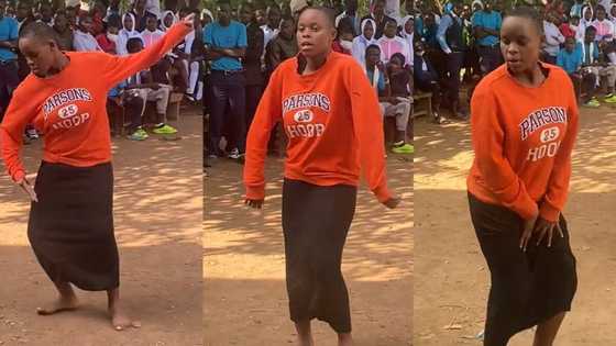 Confident young girl in long skirt dances powerfully in the midst of large crowd, TikTok video goes viral