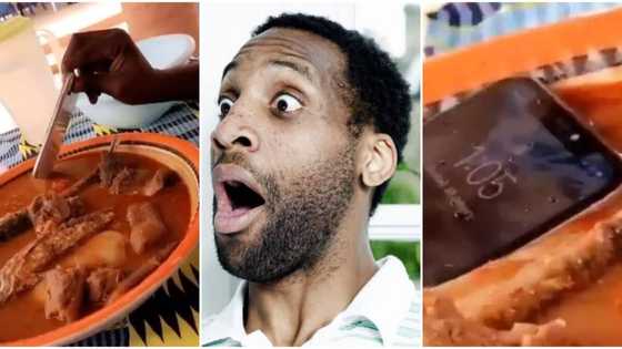 Why did he do that? Video of man dipping iPhone into fufu and soup with assorted meat and fish causes stir