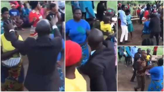 Woman fights pastor during prayer session, stops him from putting hand on her head, many people run in video