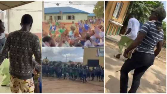 Young Nigerian man storms secondary school, causes commotion among students as he rains cash in video
