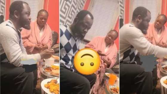 "She get hidden agenda": Nigerian woman kneels before husband to serve him food, video stirs reactions