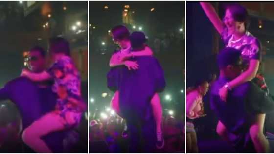 Singer Kizz Daniel carries oyinbo fan like a baby on stage, crowd goes wild, Nigerians react to viral video