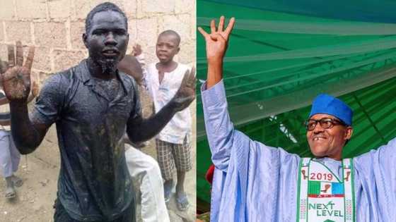 Nigerian man fulfills promise to soak himself in a dirty gutter if Buhari wins (photo)