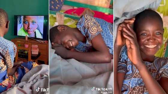 Little girl with blue eyes watches television for the first time in viral video, rolls on the bed as she spots blue-eyed kids