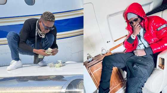 Shatta Wale gives deaf ears to Jackie Appiah's alleged lawsuit; counts dollars on private jet's wing