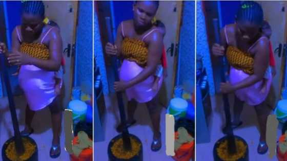 "She will age faster than her husband": Heavily pregnant woman pounds 'banga' with baby at her back