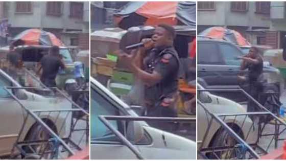 Policeman in uniform captured preaching in the rain on a busy road with speaker, video sparks reactions