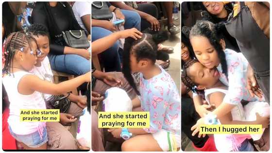 Little girl who shows kindness to another girl in the street receives prayer from her kneeling down