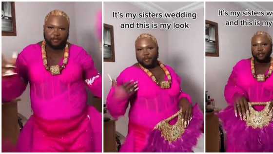 Daring man dons vibrant pink asoebi dress for sister's wedding, sports long nails and makeup