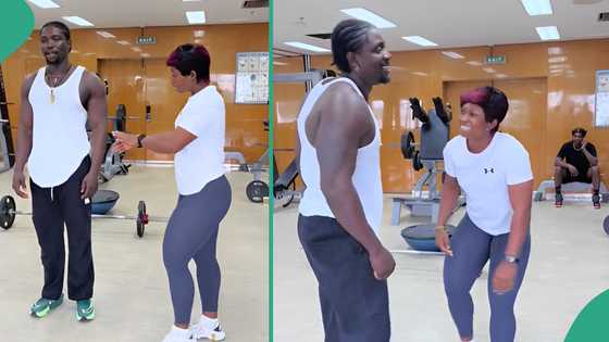 Strong lady lifts VeryDarkMan like feather, uses him to do squats at gym