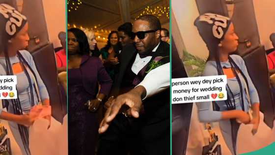 "Someone's serious babe": Lady caught on camera stealing couple's money at wedding, video emerges