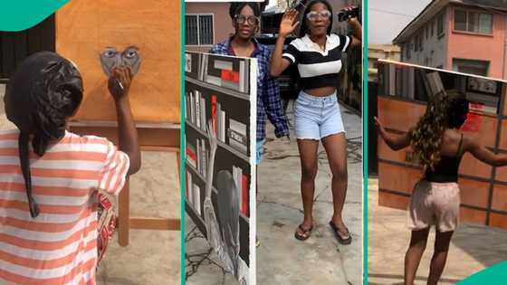 Nigerian lady shows her new artwork, depicts woman selecting book at library