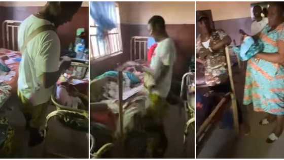 Nigerian man storms hospital, sprays N100 notes on new mother and newly born baby, video causes huge stir