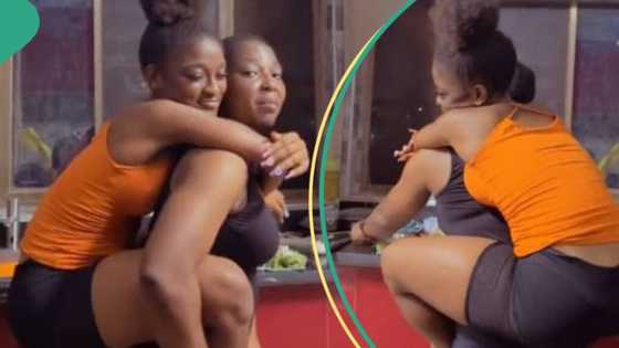 Grown-up lady jumps on African mother's back, plays with her in kitchen, video stirs reactions