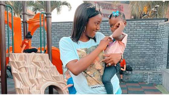 Simi takes break from being a mother, hides from daughter at the back of chair in their house, drinks wine