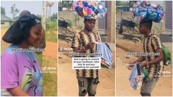 Nigerian lady gives N2k to young man hawking boxers, prays for him in emotional video