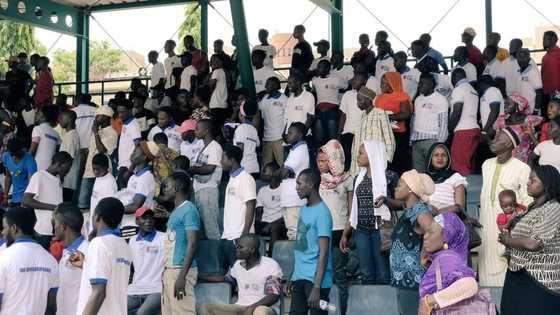 Dignitaries scamper to safety as Buhari’s supporters clash over free souvenirs in Abuja