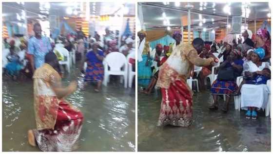 Flood! Pastor and his members spotted worshiping in waterlogged church (photos)